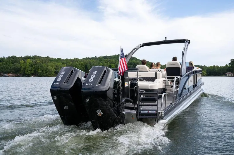 Slide: The Image of 2025 Barletta LUSSO 25UCAT pontoon boat cruising on a lake with passengers. - 7