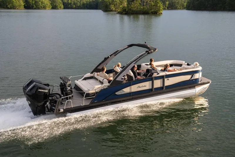 Slide: The Image of 2025 Barletta LUSSO 25UCAT pontoon boat cruising on a serene lake. - 8
