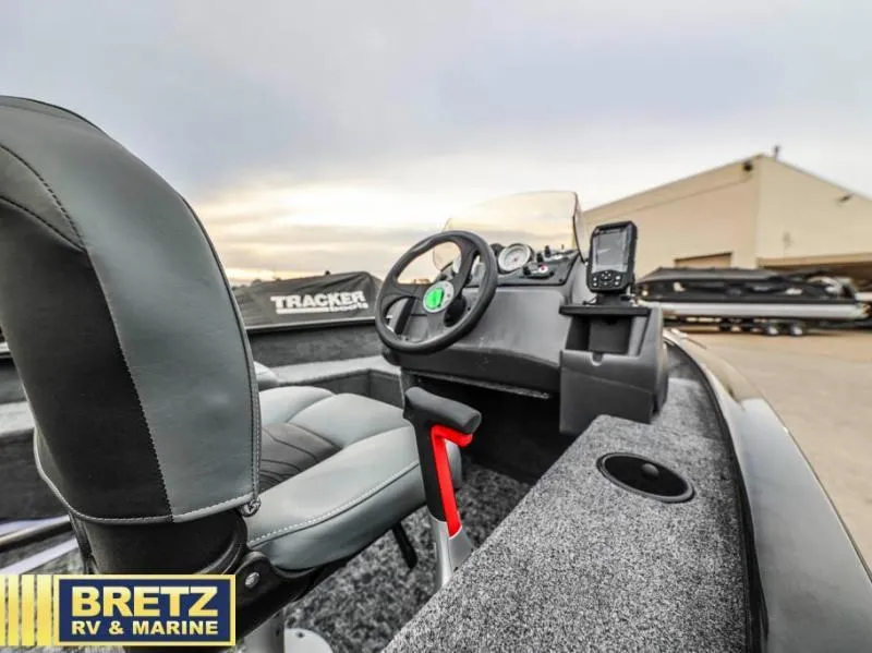 Slide: The Image of 2025 SUPER GUIDE V-16 SC boat interior with steering wheel and electronics at Bretz RV & Marine. - 9