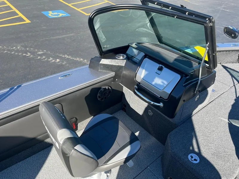 Slide: The Image of 2025 Lund 1875 Pro-V boat interior with steering console and seating. - 14