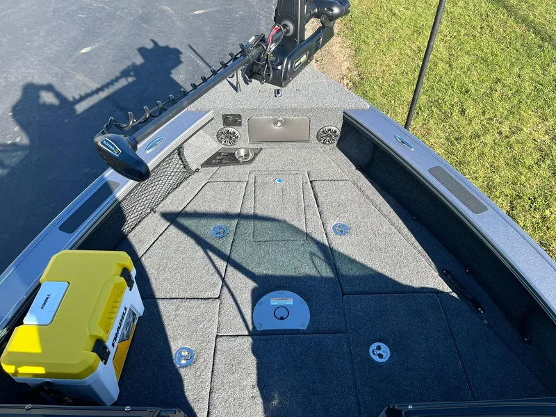 Slide: The Image of 2025 Lund 1875 Pro-V boat deck with fishing gear and storage compartments. - 19