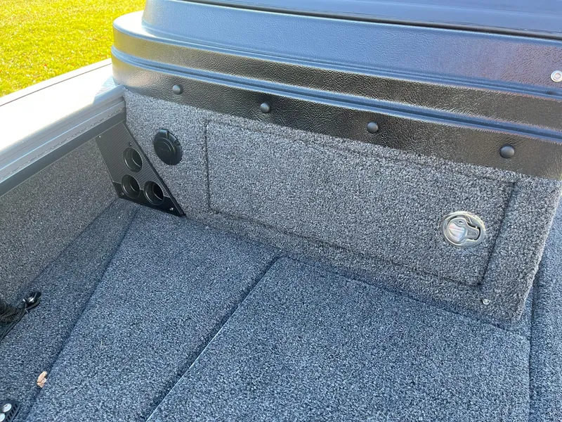 Slide: The Image of 2025 Lund 1875 Pro-V boat interior with carpeted storage compartment. - 22