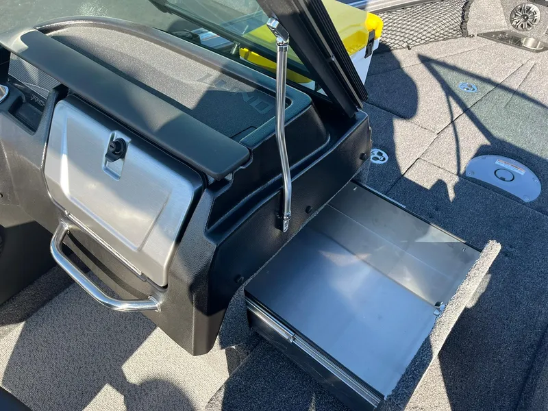 Slide: The Image of 2025 Lund 1875 Pro-V boat interior with open storage compartment and sleek design. - 23