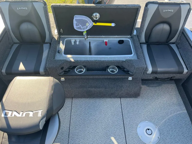 Slide: The Image of 2025 Lund 1875 Pro-V boat interior with seating and storage compartments. - 24