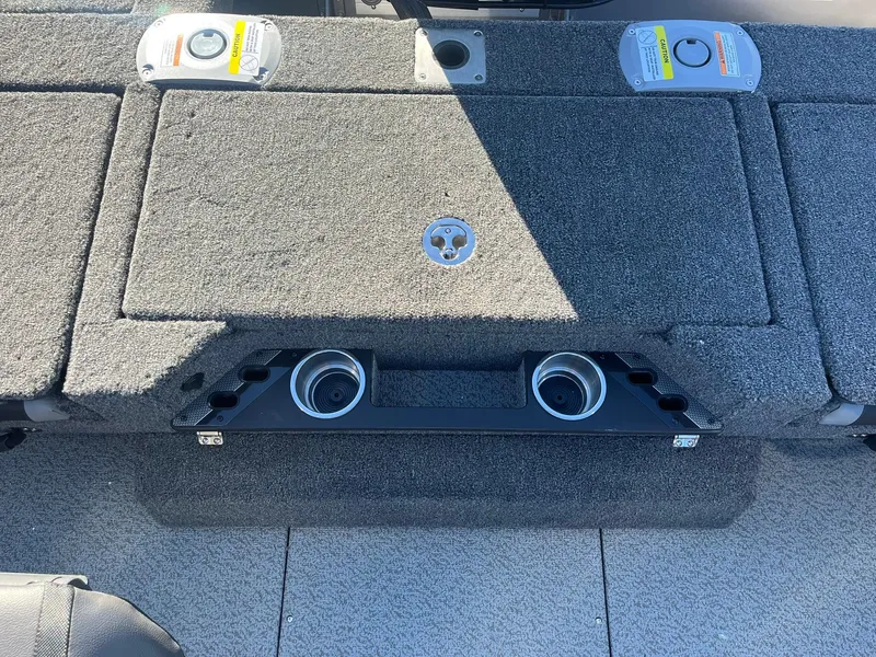 Slide: The Image of 2025 Lund 1875 Pro-V boat interior with carpeted deck and cup holders. - 26