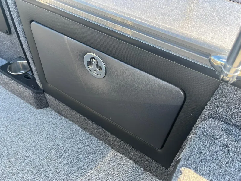 Slide: The Image of 2025 Lund 1875 Pro-V boat interior storage compartment with cup holder. - 29