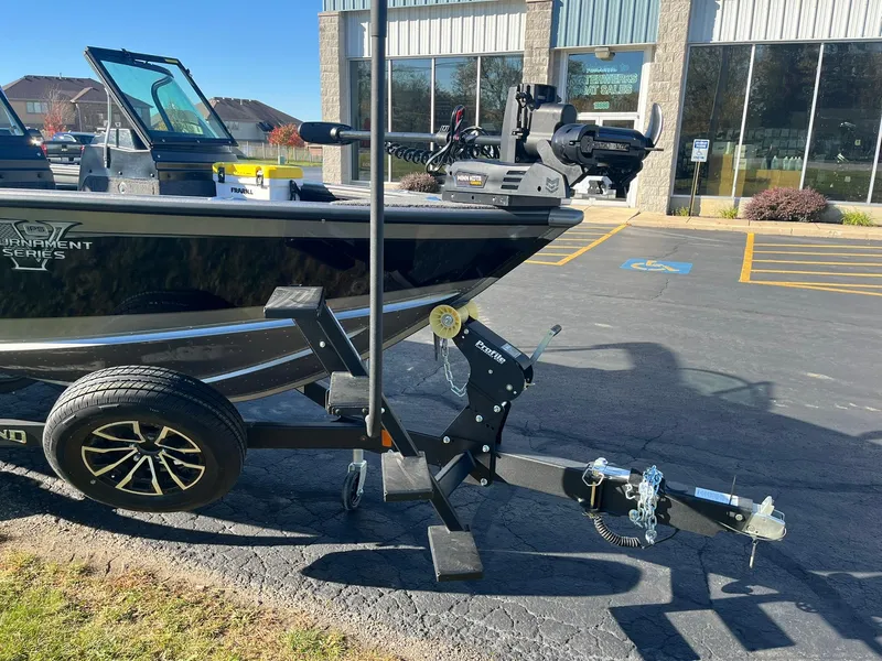 Slide: The Image of 2025 Lund 1875 Pro-V boat on trailer in parking lot, sunny day. - 3