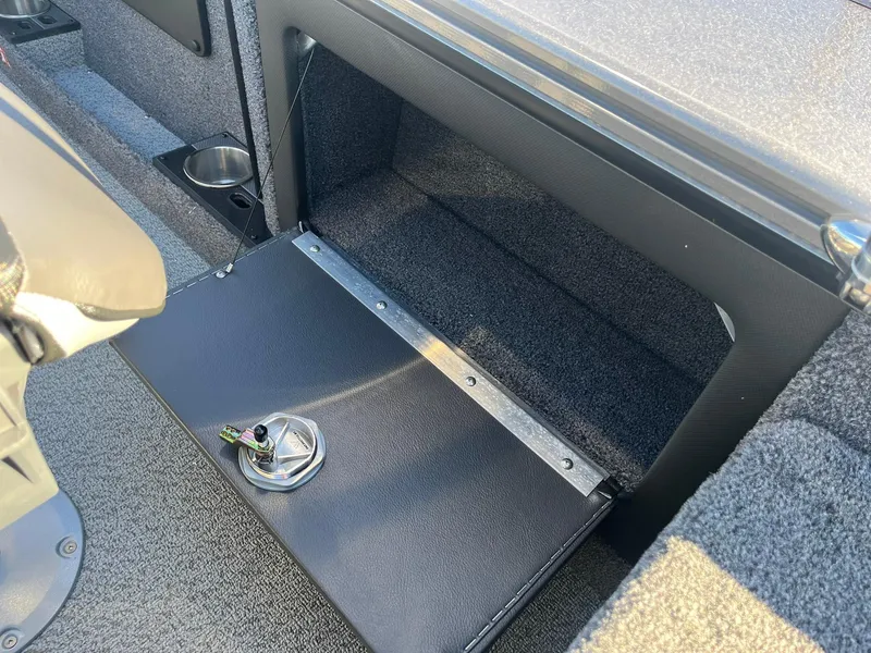 Slide: The Image of 2025 Lund 1875 Pro-V boat interior storage compartment with cup holder. - 30