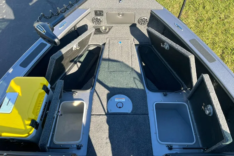 Slide: The Image of 2025 Lund 1875 Pro-V boat interior with open storage compartments and yellow cooler. - 31