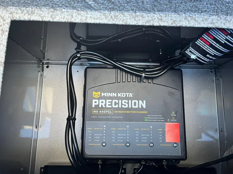 Slide: The Image of Minn Kota Precision charger in 2025 Lund 1875 Pro-V boat compartment. - 32