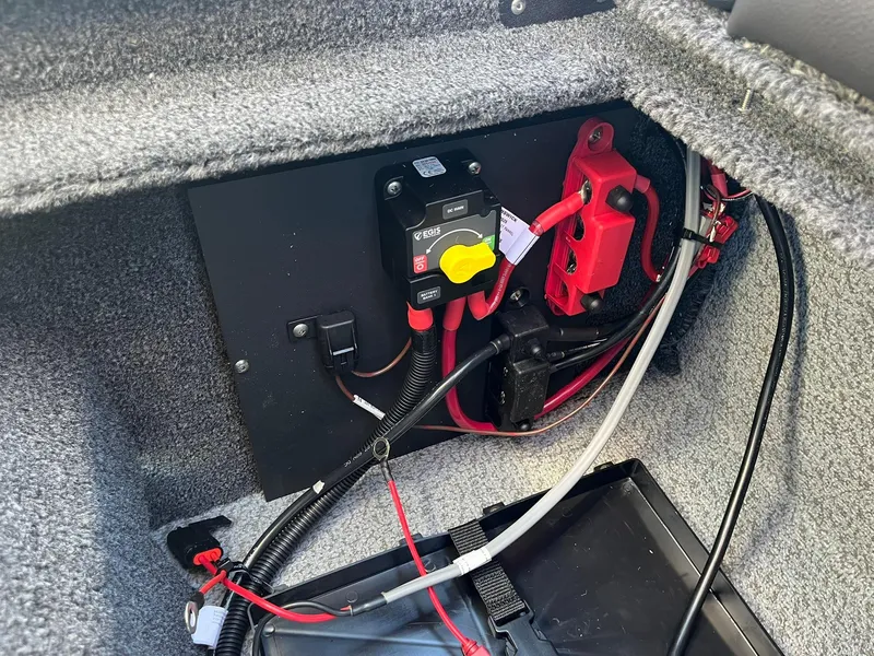 Slide: The Image of 2025 Lund 1875 Pro-V boat battery compartment with wiring and circuit breaker. - 33