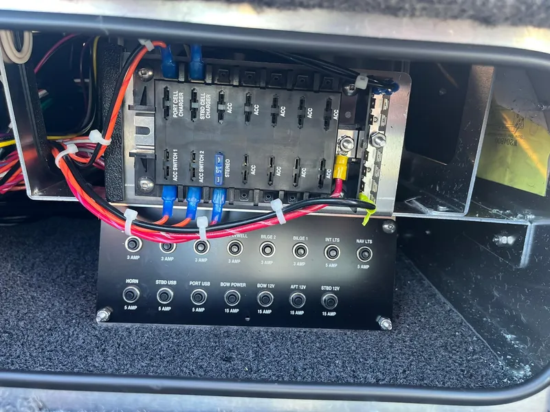 Slide: The Image of 2025 Lund 1875 Pro-V electrical panel with circuit breakers and wiring. - 35