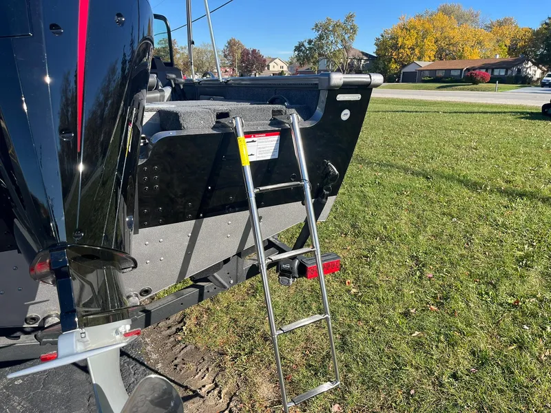 Slide: The Image of 2025 Lund 1875 Pro-V boat with ladder on grassy area. - 37