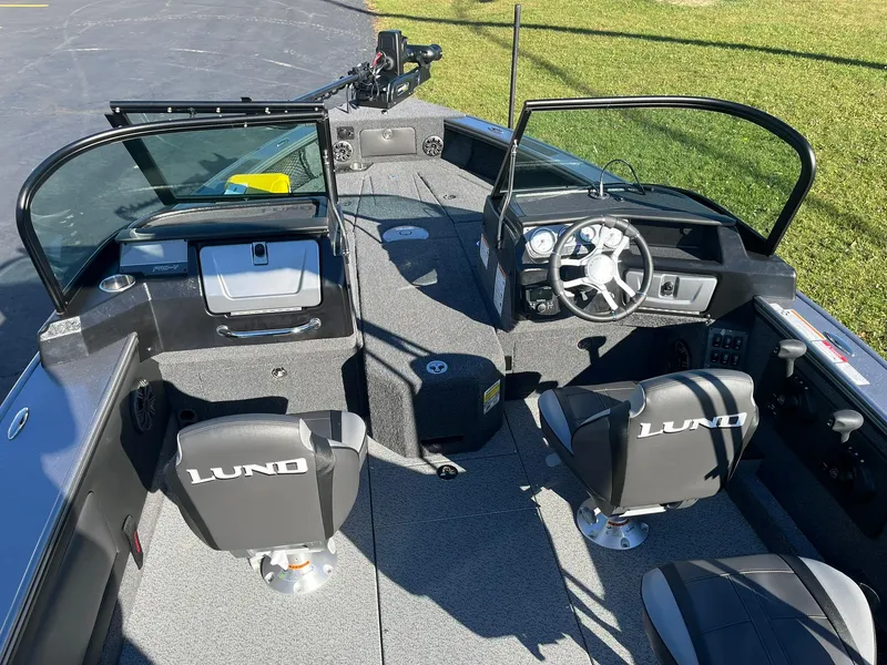 Slide: The Image of 2025 Lund 1875 Pro-V boat interior with steering wheel and seating. - 6