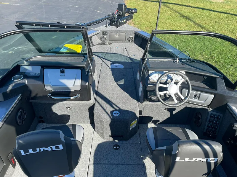 Slide: The Image of 2025 Lund 1875 Pro-V boat interior with steering wheel and seating. - 7