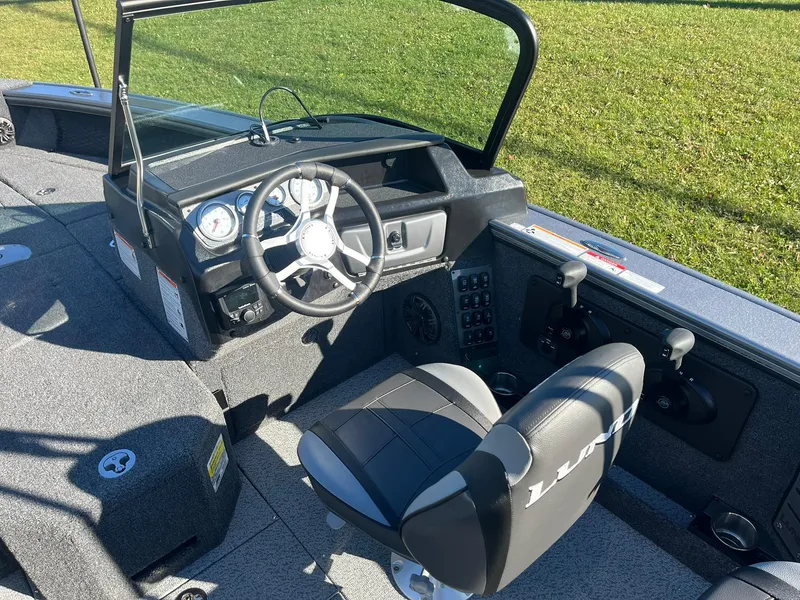 Slide: The Image of 2025 Lund 1875 Pro-V boat interior with steering wheel and seating. - 9