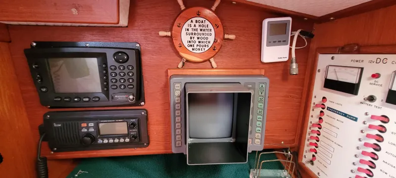 Slide: The Image of Control panel of a 1985 Mason 33 Sloop with navigation and communication equipment. - 12