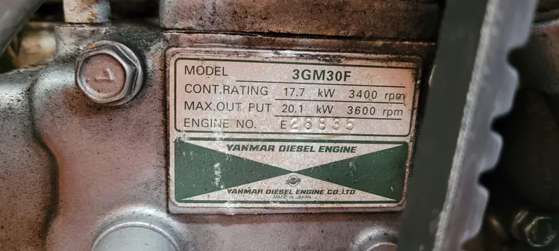 Slide: The Image of Yanmar 3GM30F diesel engine label on 1985 Mason 33 Sloop, showing power ratings and engine number. - 23
