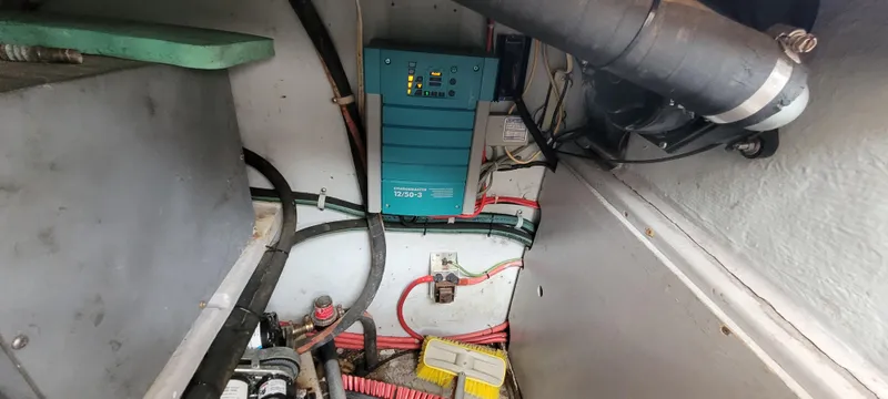 Slide: The Image of Electrical system inside a 1985 Mason 33 Sloop, featuring wiring and components. - 26
