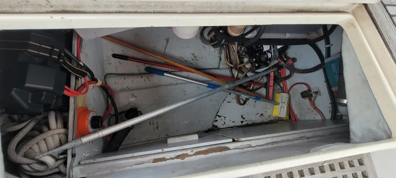 Slide: The Image of Storage compartment of a 1985 Mason 33 Sloop with ropes and tools. - 27