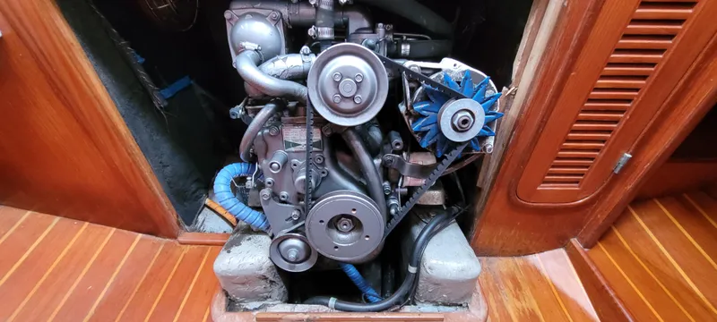 Slide: The Image of Engine of 1985 Mason 33 Sloop sailboat, showcasing mechanical components and wooden interior. - 29
