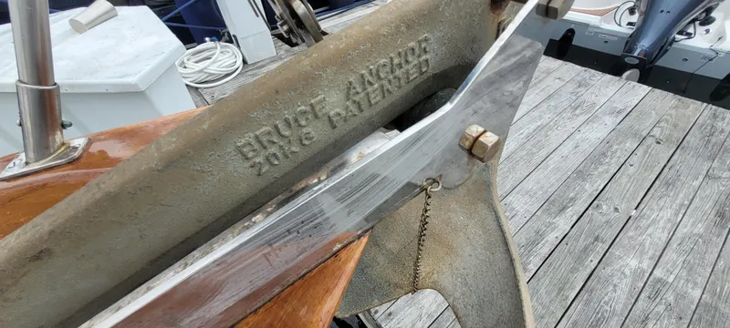 Slide: The Image of Anchor detail on a 1985 Mason 33 Sloop, docked on a wooden pier. - 35