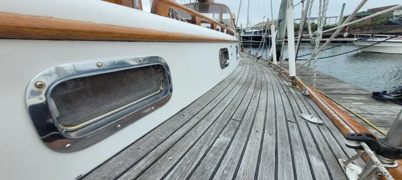 Slide: The Image of 1985 Mason 33 Sloop with wooden deck, docked at marina. - 38