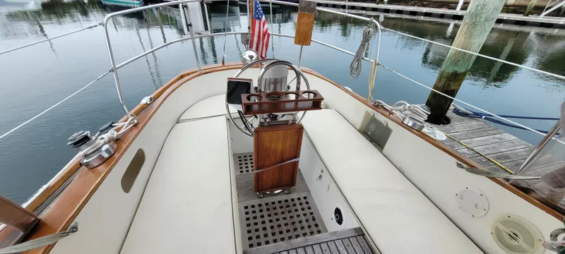 Slide: The Image of 1985 Mason 33 Sloop cockpit with steering wheel, docked at marina. - 43