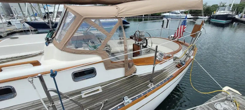 Slide: The Image of 1985 Mason 33 Sloop docked, featuring classic design and wooden accents. - 48