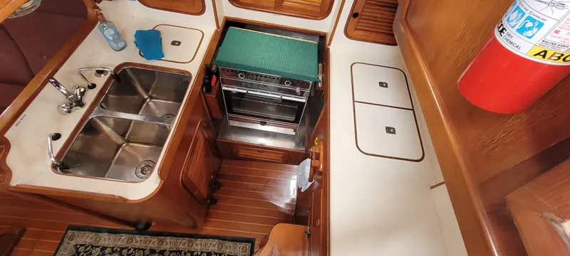 Slide: The Image of Interior of 1985 Mason 33 Sloop showing kitchen area with sink and stove. - 6