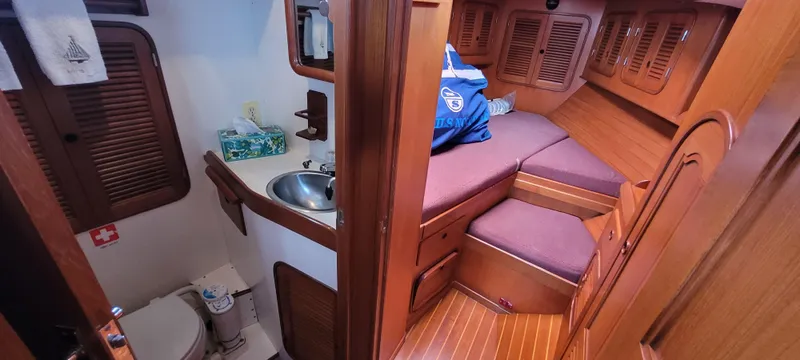 Slide: The Image of Interior of 1985 Mason 33 Sloop showing cabin and compact bathroom area. - 9
