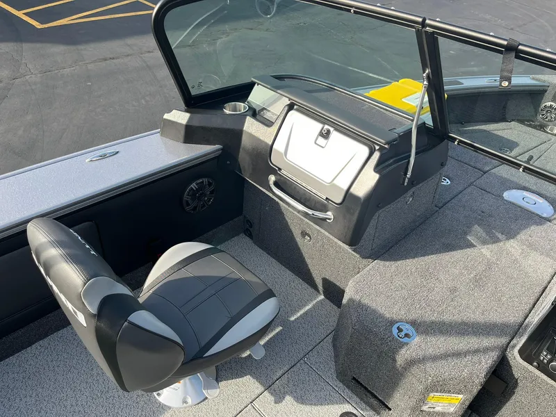 Slide: The Image of 2025 Lund 1875 Pro-V boat interior with seating and dashboard. - 16