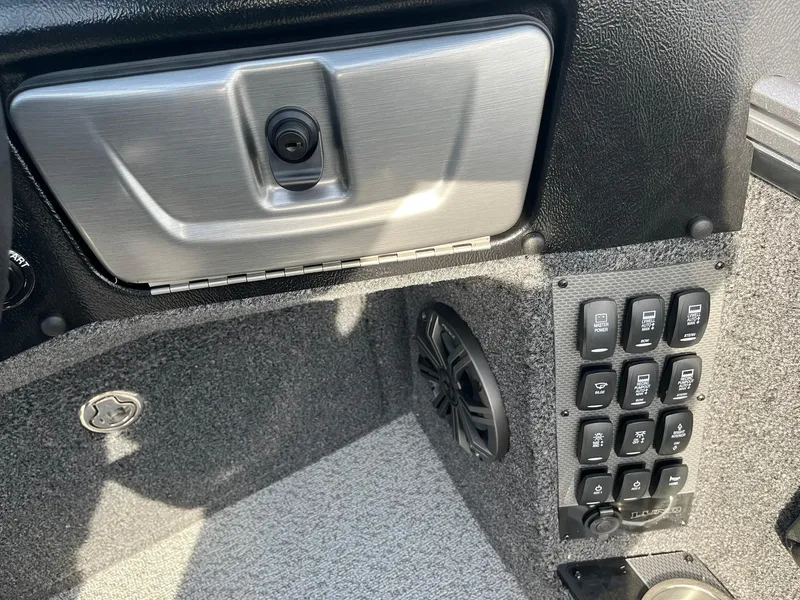 Slide: The Image of 2025 Lund 1875 Pro-V boat interior with control panel and speaker. - 18