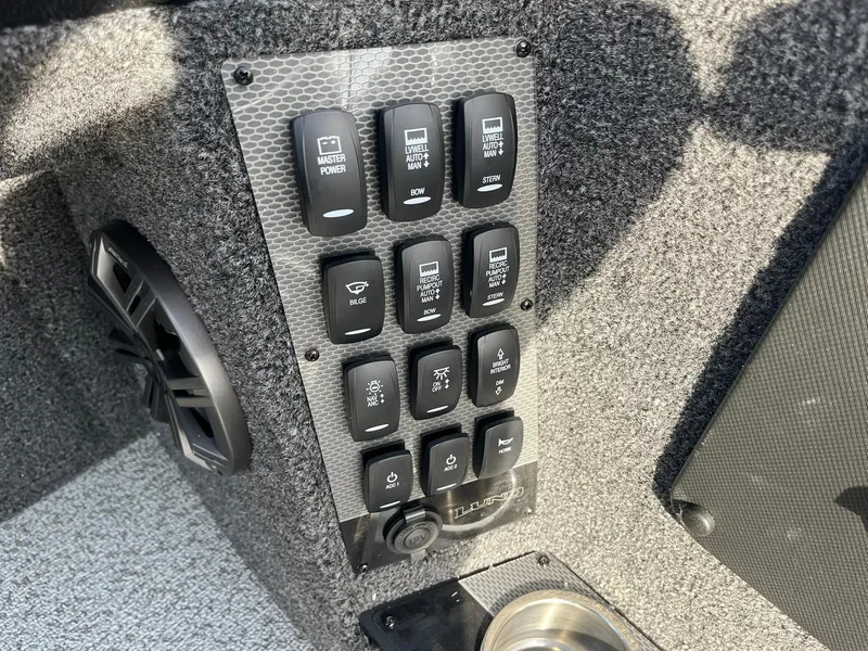 Slide: The Image of Control panel of 2025 Lund 1875 Pro-V boat with various switches. - 19