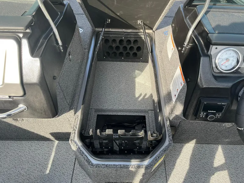 Slide: The Image of 2025 Lund 1875 Pro-V boat interior with storage compartment and control panel. - 20