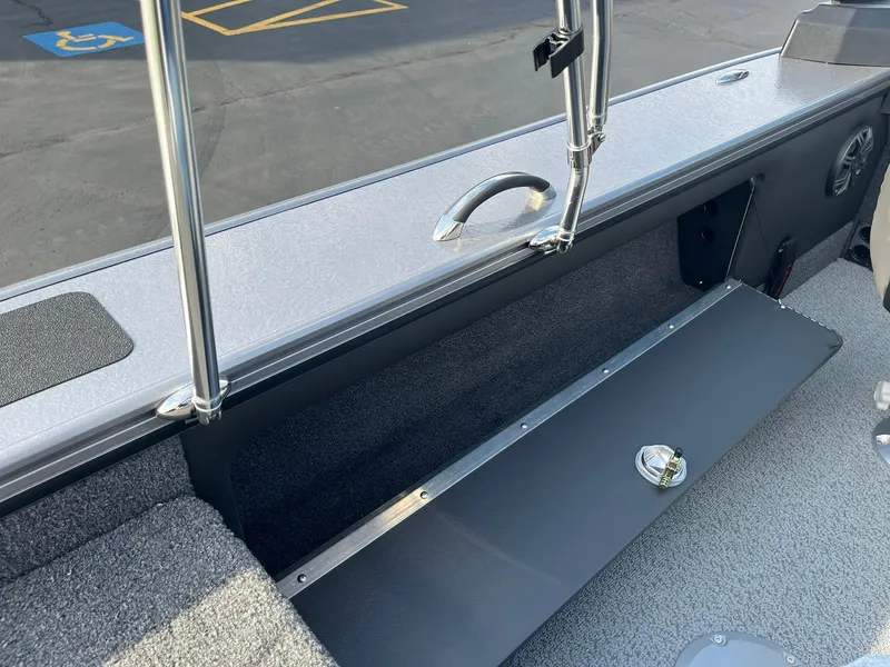Slide: The Image of 2025 Lund 1875 Pro-V boat interior with storage compartment and sleek design. - 22