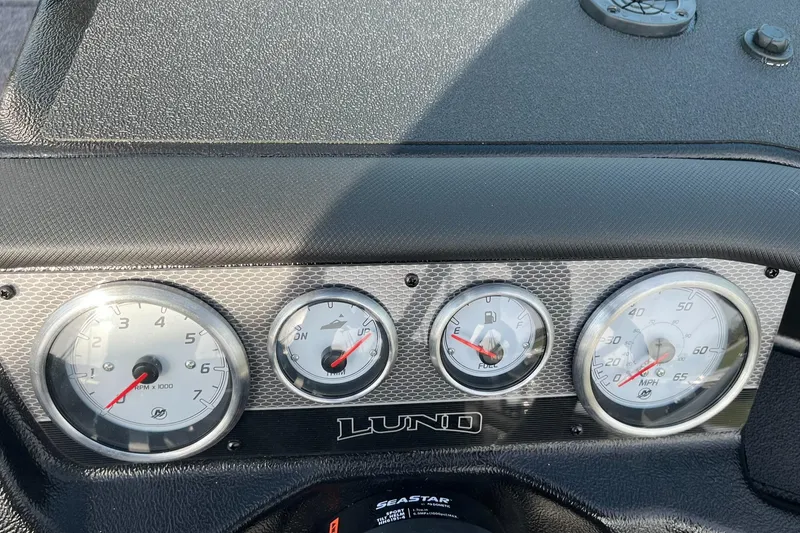 Slide: The Image of Dashboard of 2025 Lund 1875 Pro-V boat with gauges and controls. - 25