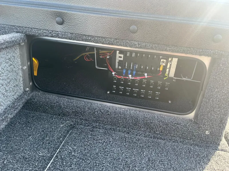 Slide: The Image of 2025 Lund 1875 Pro-V boat electrical panel with wiring and switches. - 28