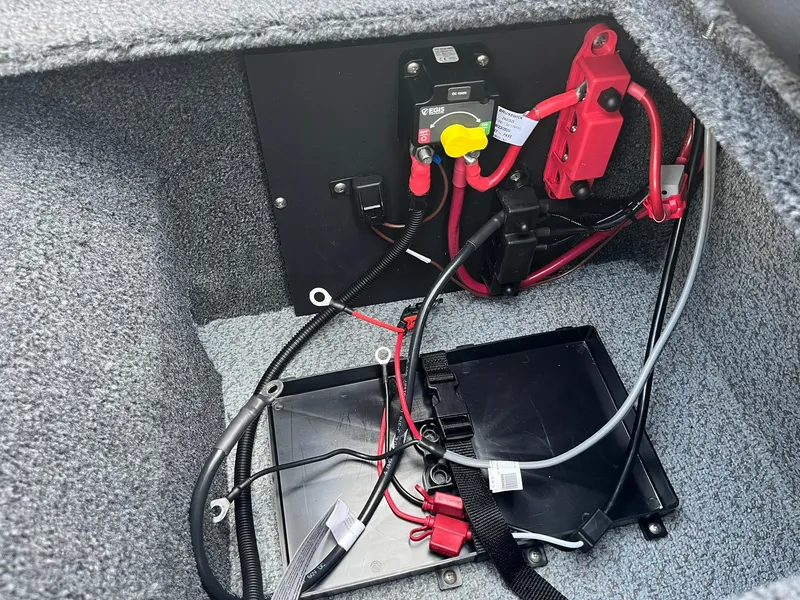Slide: The Image of 2025 Lund 1875 Pro-V boat battery compartment with wiring and connections. - 31