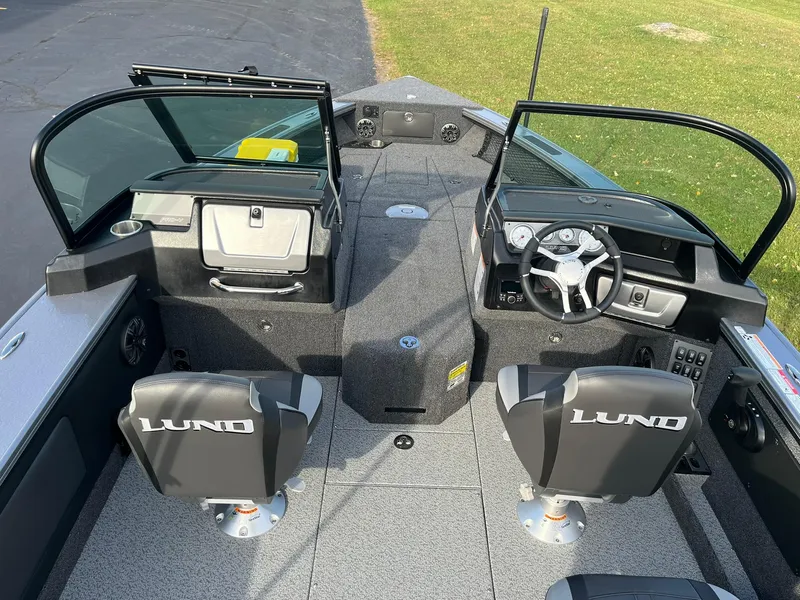 Slide: The Image of 2025 Lund 1875 Pro-V boat interior with dual seats and steering console. - 7