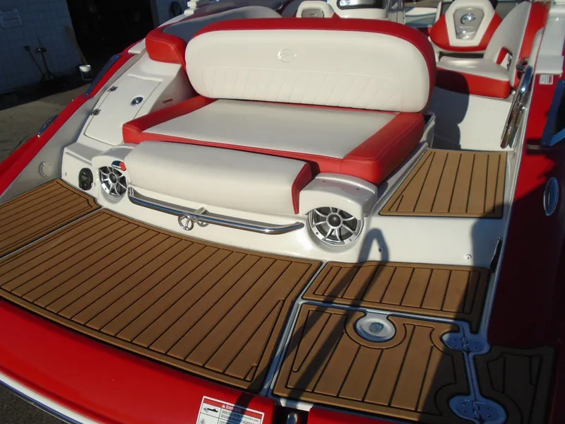 Slide: The Image of 2024 Crownline Eclipse E255 SURF boat with red and white seating, teak-style flooring. - 11