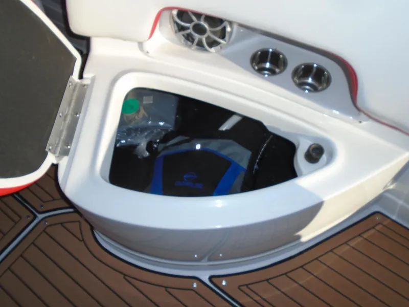 Slide: The Image of 2024 Crownline Eclipse E255 SURF boat storage compartment with speaker and cup holders. - 15