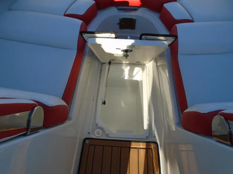 Slide: The Image of 2024 Crownline Eclipse E255 SURF boat interior with open storage compartment. - 16
