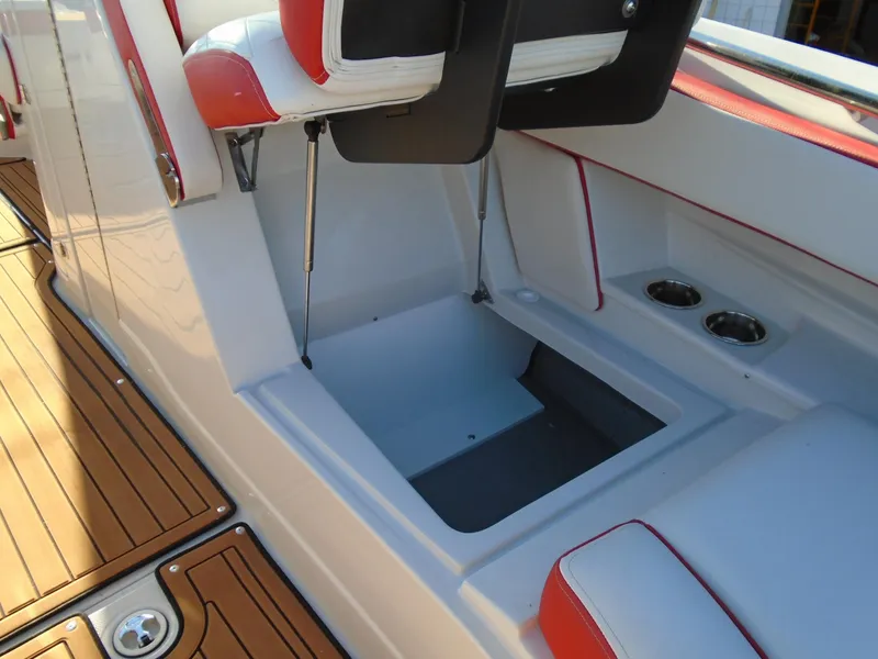 Slide: The Image of 2024 Crownline Eclipse E255 SURF boat interior with storage compartment and seating. - 17
