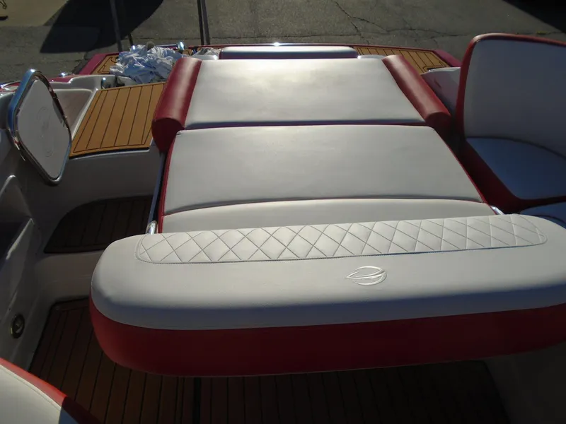 Slide: The Image of 2024 Crownline Eclipse E255 SURF boat with red and white cushioned seating. - 19