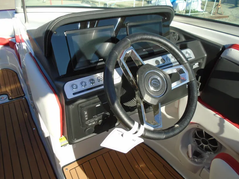Slide: The Image of 2024 Crownline Eclipse E255 SURF boat dashboard with steering wheel and controls. - 20