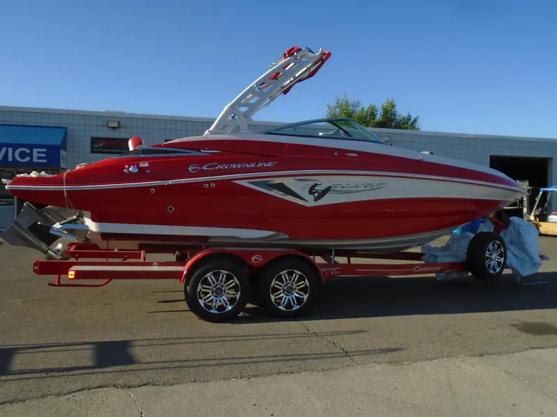 Slide: The Image of 2024 Crownline Eclipse E255 SURF boat in vibrant red on a trailer. - 3