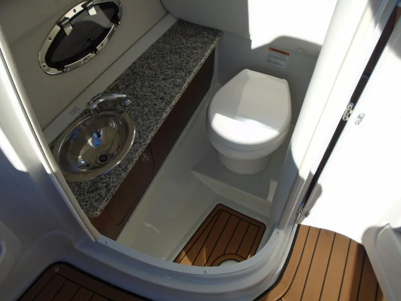 Slide: The Image of 2024 Crownline Eclipse E255 SURF boat bathroom with sink and toilet. - 6