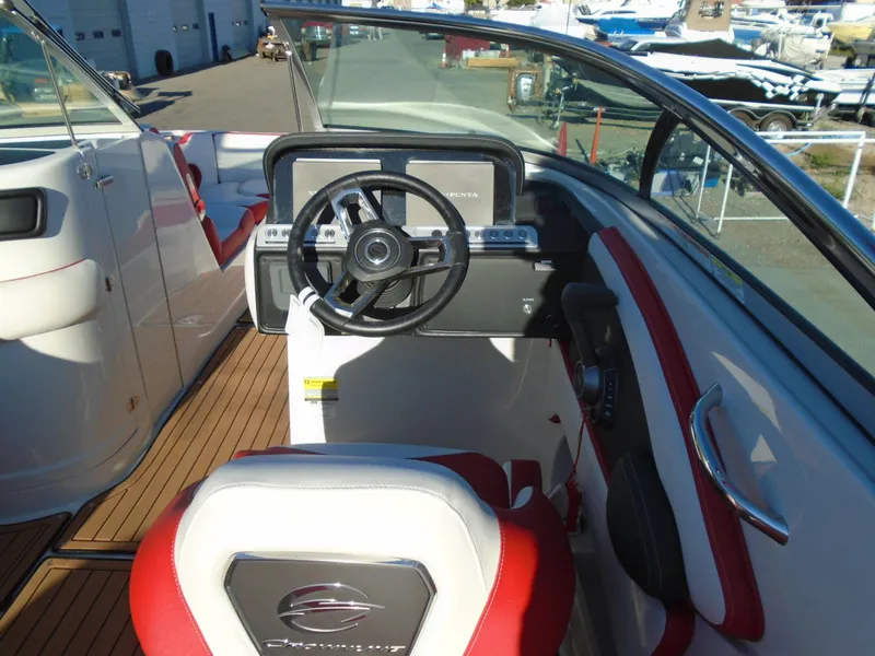Slide: The Image of 2024 Crownline Eclipse E255 SURF boat interior with steering wheel and seating. - 7
