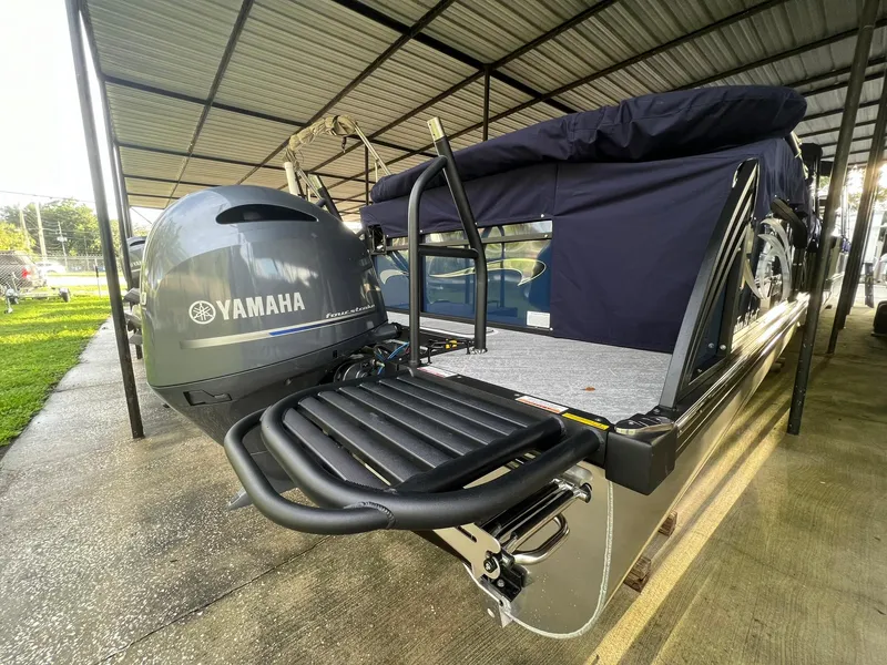 Slide: The Image of 2025 JC 21 NEPTOON TT Sport boat with Yamaha outboard motor in covered storage. - 2